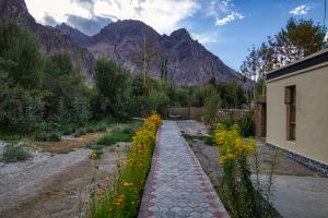 a garden with flowers in front of a building at Chalet Seabuckthorn - Hunder in Hundar