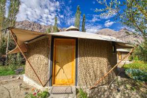 a yurt with a door and mountains in the background at Chalet Seabuckthorn - Hunder in Hundar