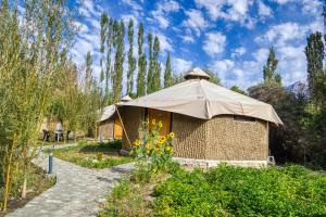 a building with a tent in a garden at Chalet Seabuckthorn - Hunder in Hundar
