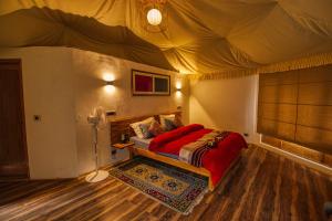 a bedroom with a bed in a tent at Chalet Seabuckthorn - Hunder in Hundar