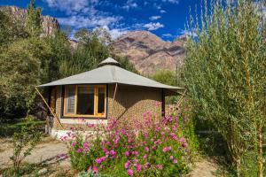 a gazebo in the middle of a field of flowers at Chalet Seabuckthorn - Hunder in Hundar