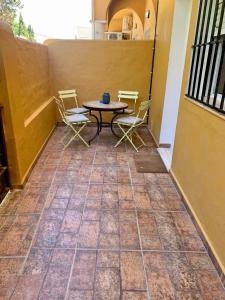 a patio with a table and chairs on a balcony at Casa a 65 metros de la Playa in El Palmar