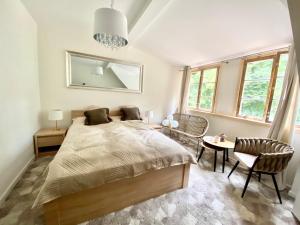 a bedroom with a bed and a table and chairs at Zamkowa 4 in Lubniewice +52 photos