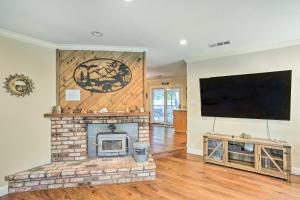 a living room with a fireplace and a flat screen tv at Charming Shasta Lake Retreat Boat, Hike and Fish! in Lakehead
