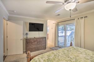 a bedroom with a bed and a flat screen tv at Charming Shasta Lake Retreat Boat, Hike and Fish! in Lakehead