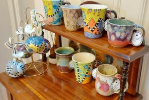 a group of cups on a wooden shelf at Barony House 5 Star Boutique BK Direct in Edinburgh