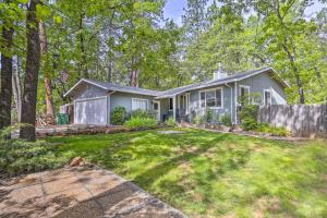 a home in the woods with a yard at Charming Shasta Lake Retreat Boat, Hike and Fish! in Lakehead