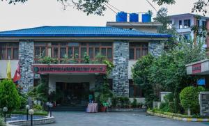 a building with a sign on the front of it at Bharatpur Garden Resort in Bharatpur