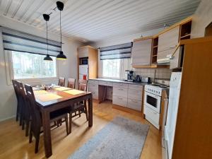 kuchnia z drewnianym stołem i jadalnią w obiekcie Mesiangervo w mieście Kalajoki