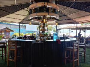 a bar in a restaurant with a chandelier at The Freedom Huts in Pokhara