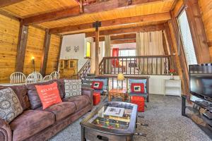a living room with a couch and a table at Big Bear Retreat with Fenced Yard Near Ski Resorts! in Big Bear Lake