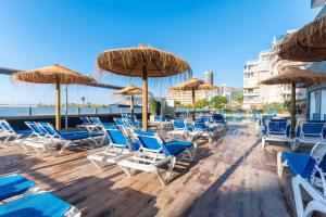 a bunch of chairs and umbrellas on a beach at Port Europa in Calpe