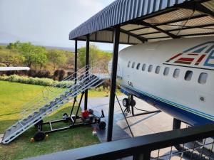 an airplane parked in a hangar with a staircase on it at AEROTEL VIP in Hoedspruit