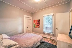 a bedroom with a bed and a window at Historic Apartment - Walk to CSU Campus and Old Town in Fort Collins