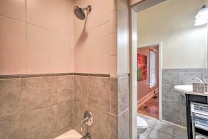 a bathroom with a shower with a toilet and a sink at Historic Apartment - Walk to CSU Campus and Old Town in Fort Collins