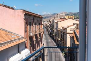 a view of a city street from a balcony at Appartamento Moderno in Centro città in SantʼAgata di Militello