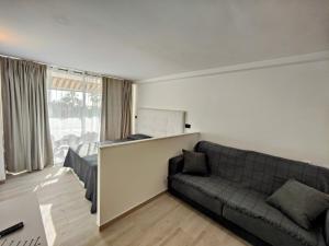 a living room with a couch and a large window at ESTUDIO DEBORA in Playa Fañabe +11 photos