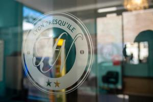 a reflection of a sign in a window of a store at Hotel de Normandie in Lyon