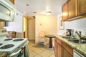 a kitchen with a stove and a sink and a table at Pet-Friendly Las Vegas Condo 1 Mi to the Strip! in Las Vegas