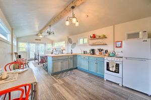 a kitchen with blue cabinets and a white refrigerator at Studio with Mountain Views, Less Than 30 Min to Durango! in Mancos