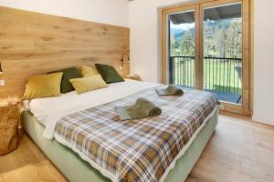 a bedroom with a bed with two hats on it at Violet a due passi da Bormio in Valdidentro