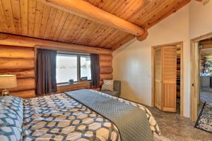 a bedroom with a bed and a large window at Fairbanks Log Cabin with Waterfront Deck and Views! in Fairbanks