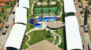 an aerial view of a resort with a swimming pool at Ancorar flat resort paradise in Porto De Galinhas