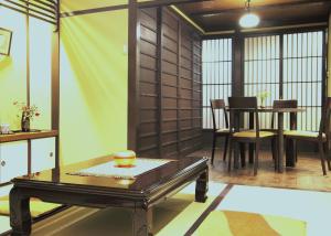 a living room with a table and a dining room at Gion Kyuraku in Kyoto