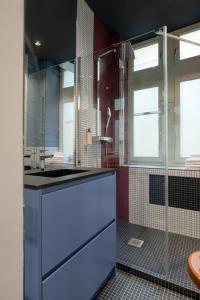 a bathroom with a sink and a shower at MiHotel Saint Jean in Lyon