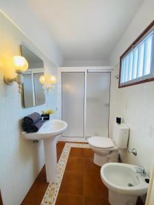 a bathroom with two sinks and a toilet and a window at NEW ELEGANCE TRADITIONAL CANARIAN HOME CASA MÁ , Tenerife South in Arona