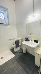a white bathroom with a sink and a toilet at NEW ELEGANCE TRADITIONAL CANARIAN HOME CASA MÁ , Tenerife South in Arona