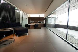 a living room with a couch and a table at Sapporo boukyo Luxury house 5 pax Free Parking in Sapporo