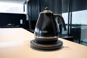 a black tea kettle sitting on top of a table at Sapporo boukyo Luxury house 5 pax Free Parking in Sapporo