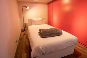 a bedroom with a bed with a towel on it at Sapporo boukyo Luxury house 5 pax Free Parking in Sapporo +65 photos
