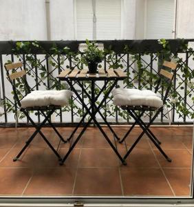 a patio table with two chairs and a potted plant at CHEZ GREDOS in Candeleda +12 photos