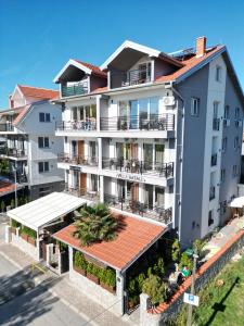 an apartment building with a red roof at Villa Natali in Ohrid