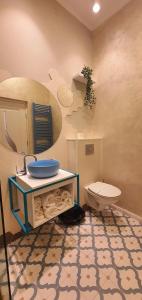 a bathroom with a sink and a toilet at OITUZ Boutique Residence in Mangalia