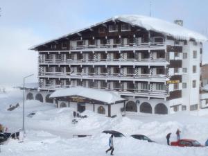 a large building covered in snow with people in front of it at Beceren Hotel in Bursa
