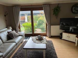 uma sala de estar com um sofá e uma mesa de centro em Veluwe Park Reewold Chalet Infinity em Putten