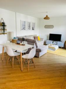 a living room with a white table and chairs at Salt Yard Apartment, Parking and Terrace, Whitstable in Whitstable
