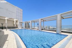 a swimming pool on the roof of a building at bnbmehomes - Cosy Downtown Apt w Balcony Near Metro Station -1710 in Dubai