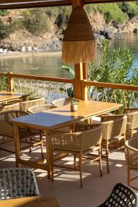 a table and chairs on a patio with a view of the water at Bali Star Resort Hotel in Balíon