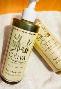 a bottle of olive oil and a bottle of lotion at Charlie's Hôtel Cannes in Cannes