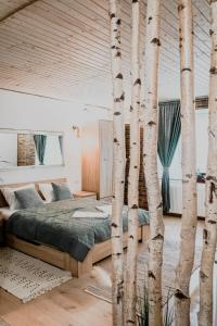 a bedroom with a bed and some trees at Central garden apartments in Braşov