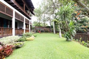 un patio de una casa con césped verde y un parque infantil en Rumah Pelita near Lembang FREE WIFI - Villa Lantera en Bandung