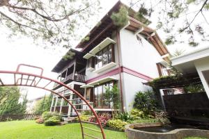 a house with a playground in front of it at Rumah Pelita near Lembang FREE WIFI - Villa Lantera in Bandung
