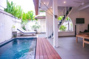 a swimming pool in the middle of a house at Villa Olivia in Seminyak