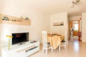 a living room with a table and a television at Albufeira Old Town Two bedroom Apartment Center in Albufeira