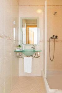 a bathroom with a sink and a shower with a mirror at Albufeira Old Town Two bedroom Apartment Center in Albufeira