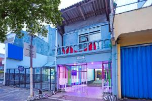 OYO 91867 Gangnam Style Kutai في سورابايا: مبنى أزرق عليه لافتة نيون